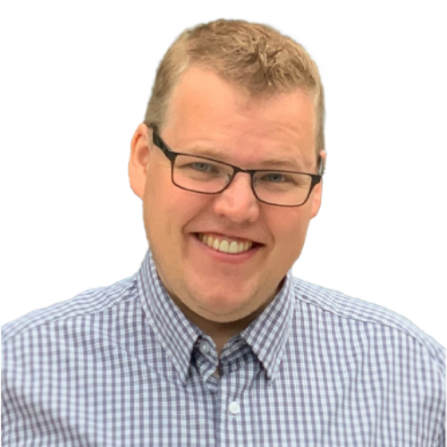 Headshot of a grinning man wearing glasses and a plaid shirt. width=